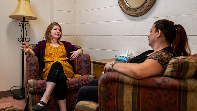 Woman counseling another woman.